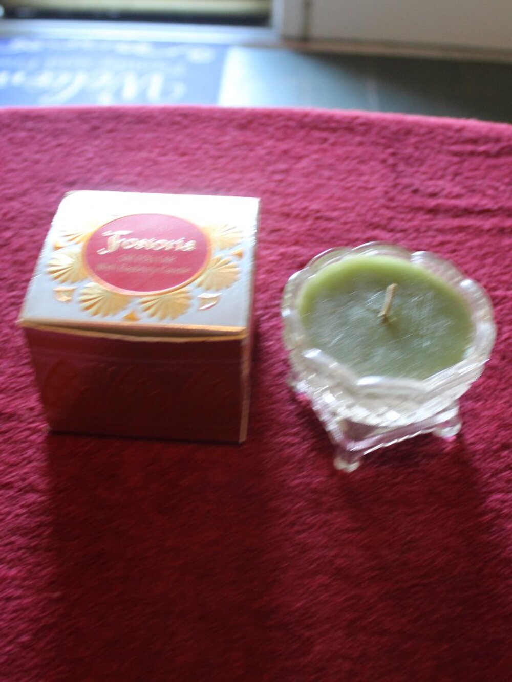 vintage Avon Fostoria glass salt cellar containing a green bayberry candle